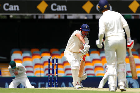 Cricket - Ashes test match - Australia v England - GABBA Ground, Brisbane, Australia, November 23, 2017. England's Alastair Cook is caught by Australia's Steve Smith, as England's Mark Stoneman looks on, during the first day of the first Ashes cricket test match. REUTERS/David Gray