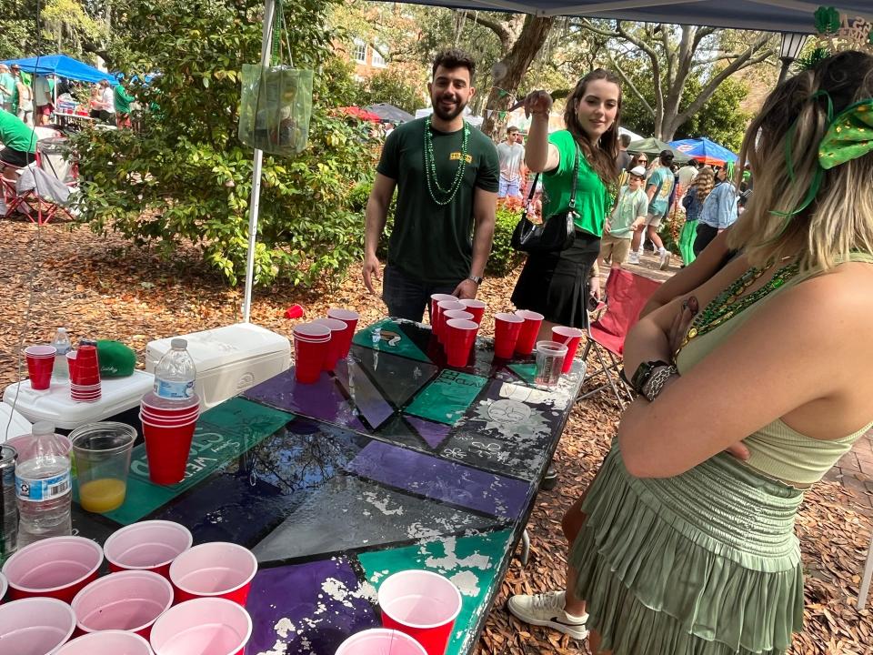 Lauren Rockwell, a Savannah College of Art and Design student from New York City, tries her hand at beer pong. Rockwell and about a dozen friends were set up in Chippewa Square.