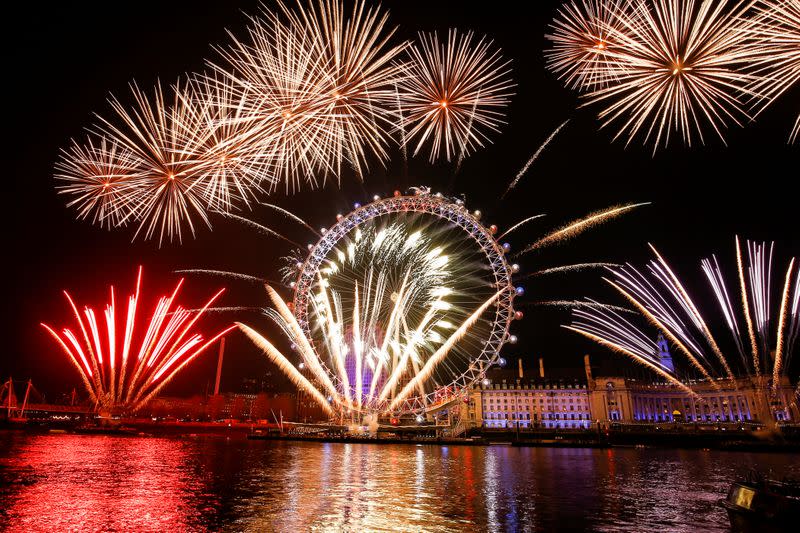 Fireworks explode over the London Eye wheel during New Year celebrations in central London