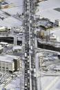 Vehicles are stranded due to heavy snow at Japan National Route 1 in Kyoto, western Japan Wednesday, Jan. 25, 2023. Snow and cold weather were affecting much of Japan on Wednesday, disrupting highway, air and train travel, and more snow and cold temperatures were forecast. (Kyodo News via AP)