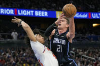 Orlando Magic's Moritz Wagner (21) tries to shoot against New York Knicks' Jericho Sims during the second half of an NBA basketball game Tuesday, Feb. 7, 2023, in Orlando, Fla. (AP Photo/John Raoux)