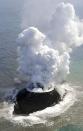 Smoke from an erupting undersea volcano forms a new island off the coast of Nishinoshima, a small uninhabited island, in the southern Ogasawara chain of islands in this November 21, 2013 picture provided by Kyodo. Japan added another small area to its territory on Wednesday after the undersea volcano eruption in the southern Ogasawara chain of islands led to the birth of a small new one. Mandatory Credit. REUTERS/Kyodo