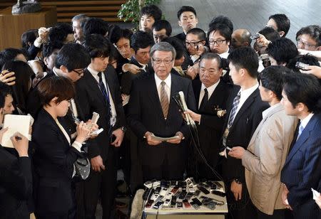 Okinawa Governor Takeshi Onaga (C) speaks to reporters after a meeting with Japan's Prime Minister Shinzo Abe (not in picture) at Abe's official residence in Tokyo, 17 April 2015. REUTERS/Franck Robichon/Pool