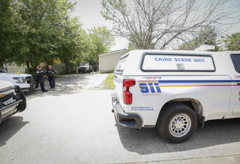 Police work at a crime scene on Bayou Forest Drive after two people, including a pregnant woman, were fatally shot at a soccer park, Sunday, July 25, 2021, in Houston. A man who fatally shot his pregnant ex-wife and her boyfriend in the parking lot of a Houston soccer park as children played in a tournament was later found dead from a self-inflicted gunshot, authorities said. (Steve Gonzales/Houston Chronicle via AP)