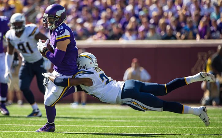 Minnesota Vikings wide receiver Adam Thielen is tackled by San Diego Chargers defensive back Patrick Robinson during the third quarter at TCF Bank Stadium.