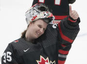 Canada goaltender Ann-Renee Desbiens gives a thumbs-up to the crowd following the team's win over Czechia in a semifinal at the women's world hockey championships in Utica, N.Y., Saturday, April 13, 2024. (Christinne Muschi/The Canadian Press via AP)