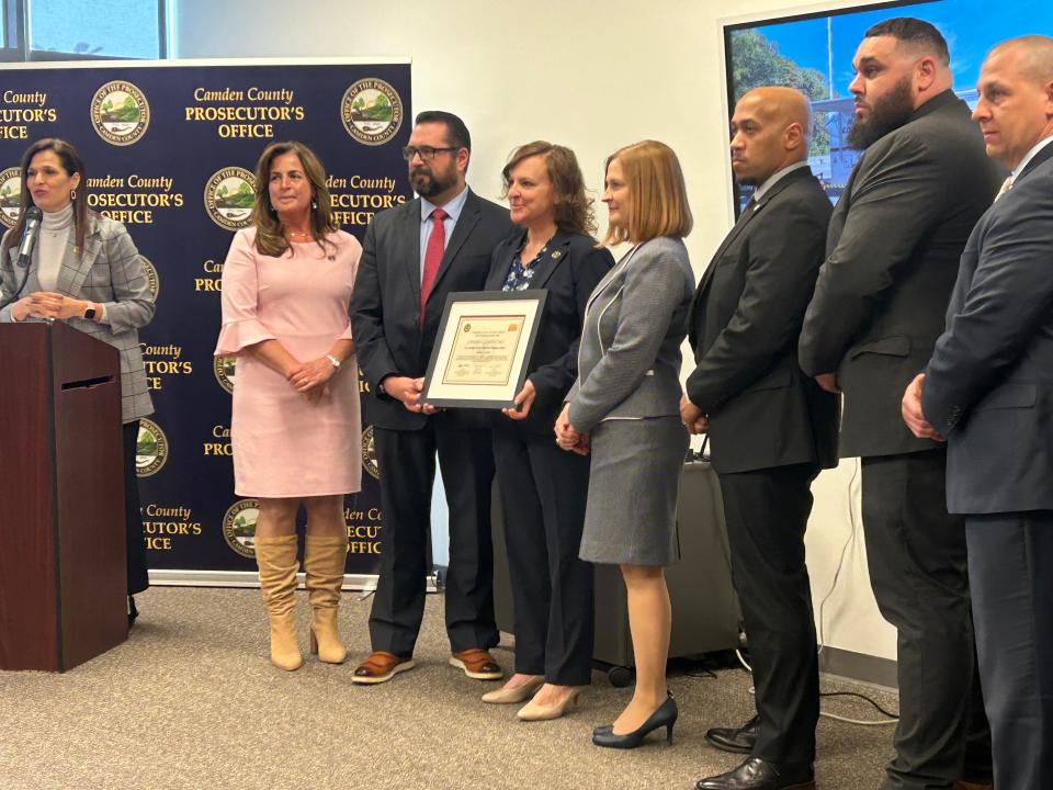 Fawn Landay (center, holding plaque) of the Camden County Prosecutor's Office and the Camden County Child Abduction Response Team received a national certification for their work in March. Landay talked about the agency's Special Needs Registry, which offers information to law enforcement about people with conditions including autism, dementia, PTSD and mental illness.