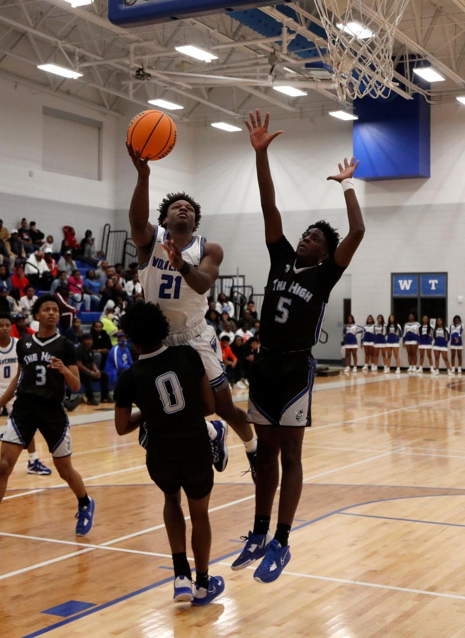 Woodville-Tompkins' Alfonzo Ross attempts a basket between Savannah High's Chance Hendricks and Nayshawn Heyward during the Region 3A Div.1 Title game.