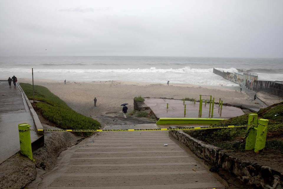 People ignore caution signs for beach closings at Las Playas de Tijuana as Tropical Storm Hilary heads toward the city on Sunday, Aug. 20, 2023, in Tijuana, Baja California. (Ana Ramirez/The San Diego Union-Tribune via AP)