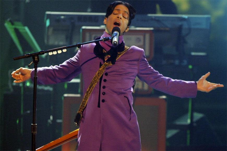 All-purple-everything was the call for Prince, who hit the stage in a long purple jacket with prominent buttons, matching pants, a scarf, and a guitar with a supercool animal print strap slung over his shoulders.