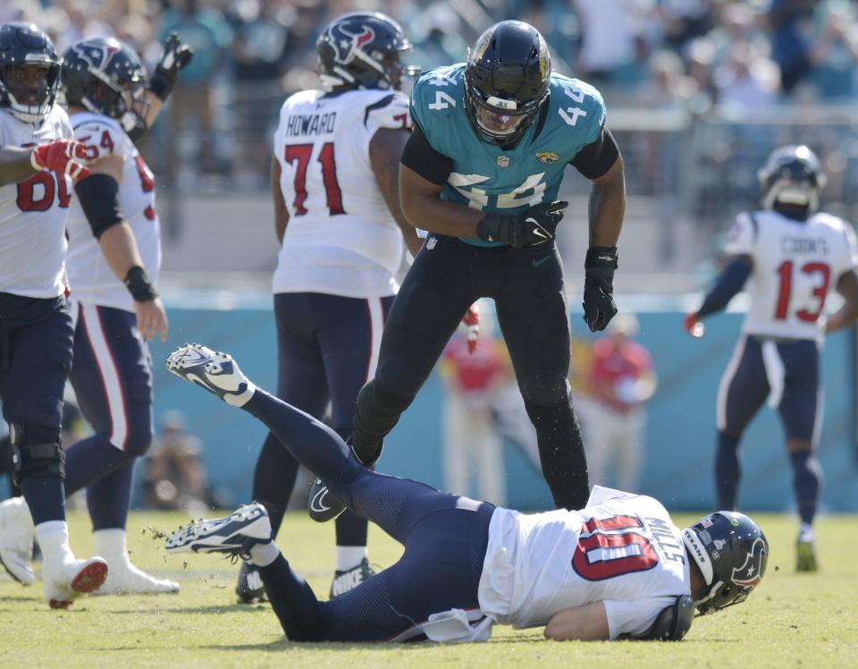 Jacksonville Jaguars linebacker Travon Walker (44) slings Houston Texans quarterback Davis Mills (10) to the turf after he released the ball during mid fourth quarter action. The Jacksonville Jaguars hosted the Houston Texans at TIAA Bank Field in Jacksonville, FL Sunday, October 9, 2022. The Jaguars fell to the Texans with a final score of 13 to 6.[Bob Self/Florida Times-Union]