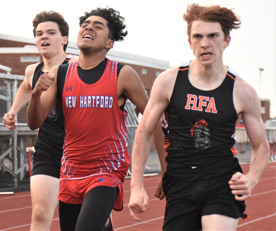 Rome Free Academy Black Knight Nolan Moore (right) races teammate Grady Engelbert and New Hartford Spartan Samson Allen (from left) to the finish line of the 800-meter race Wednesday. Moore won the race but New Hartford won the meet 73-68.