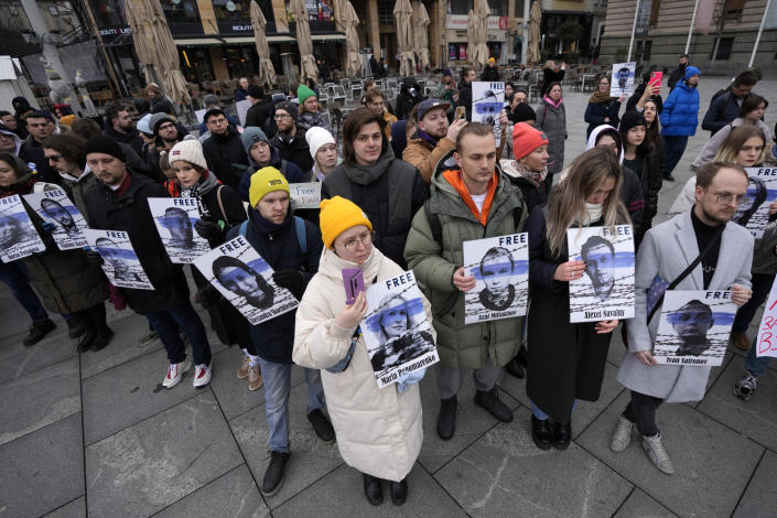 People hold pictures of Russia's political prisoners during a rally in Belgrade, Serbia, Saturday, Jan. 21, 2023. A friendly, fellow-Slavic nation, Serbia has welcomed the fleeing Russians who need visas to travel to much richer Western European states. But in Serbia, they have not escaped the long reach of Putin's hardline regime influence.(AP Photo/Darko Vojinovic)