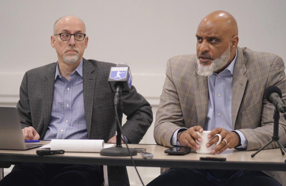 Major League Baseball union head Tony Clark, right, speaks as chief negotiator for the players association Bruce Meyer looks on during a media availability in Irving, Texas, Thursday, Dec. 2, 2021. Owners locked out players at 12:01 a.m. Thursday following the expiration of the sport's five-year collective bargaining agreement.(AP Photo/LM Otero)