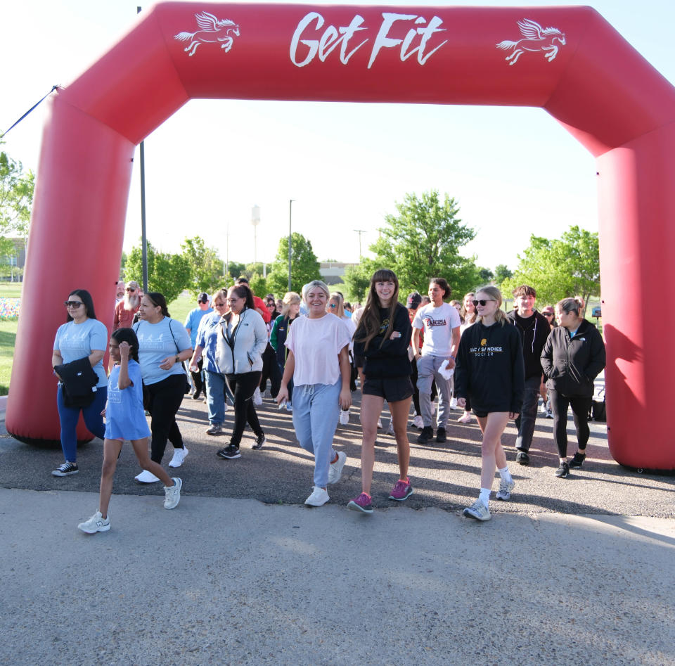 Attendees start the "Walk a Mile in Their Shoes,” a one-mile run/walk event at The Bridge Children's Advocacy Center in Amarillo on Saturday.