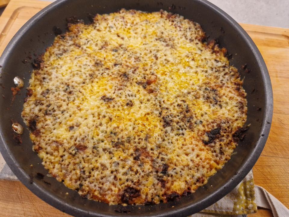 hash browns covered in cheese in a pan