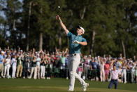 Rory McIlroy, of Northern Ireland, throws his ball to the gallery on the 18th green during the final round at the Masters golf tournament on Sunday, April 10, 2022, in Augusta, Ga. (AP Photo/Matt Slocum)