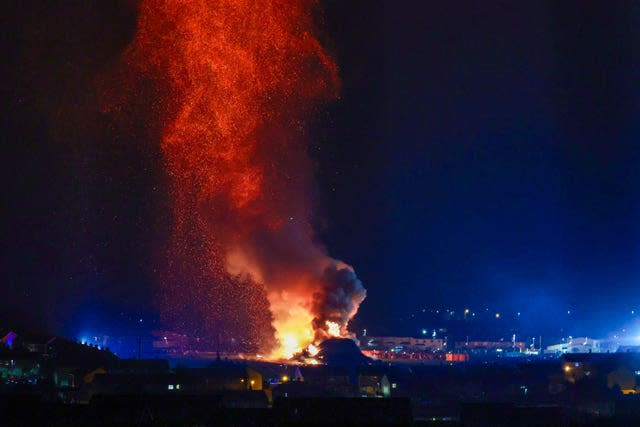 People watch the burning of the Craigyhill loyalist bonfire in Larne, Co Antrim