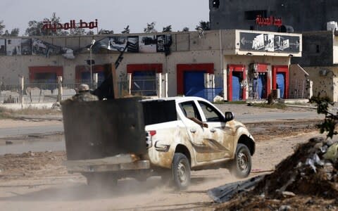 A vehicle belonging to Libyan fighters loyal to the Government of National Accord (GNA) is pictured during clashes with forces loyal to strongman Khalifa Haftar south of the capital Tripoli's suburb of Ain Zara - Credit: MAHMUD TURKIA/AFP