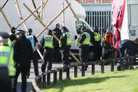 Police outside the Newsprinters printing works at Broxbourne, Hertfordshire. Protesters continue to use bamboo lock-ons and a van to block the road. (Photo by Yui Mok/PA Images via Getty Images)