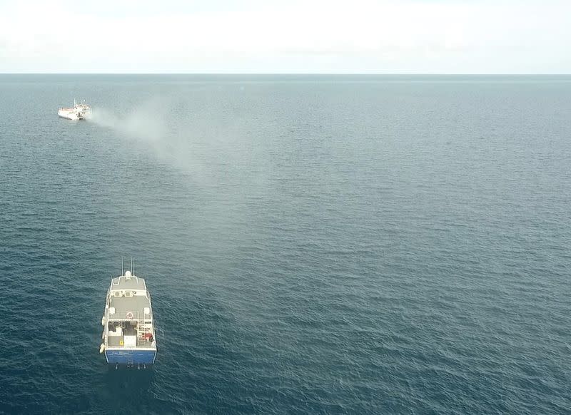 Plume from a seawater sprayer is seen during the second field trial at Broadhurst Reef on the Great Barrier Reef