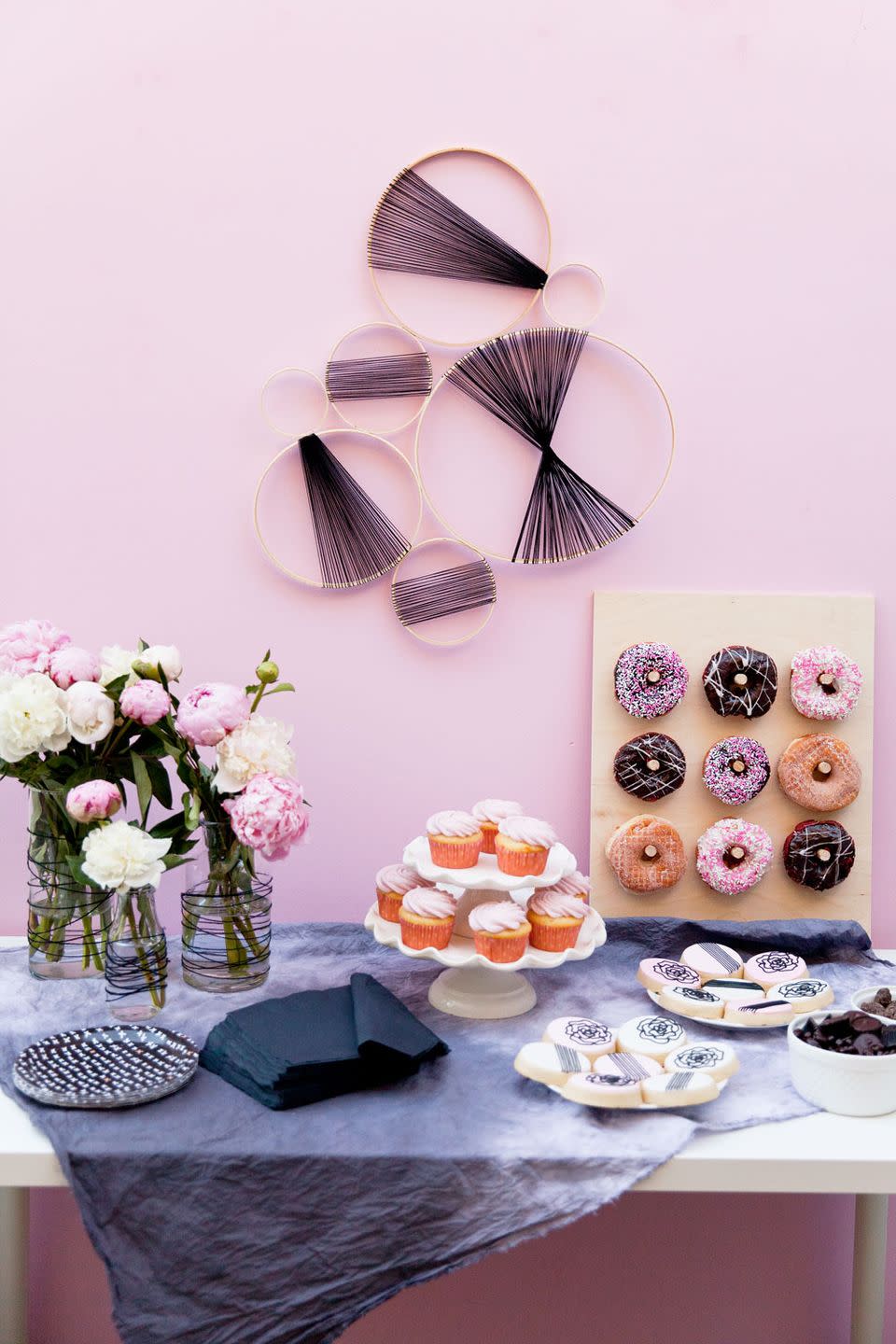 thie black and pink themed shower, a great idea for a baby shower, features embroidery hoops, cupcakes, and donuts
