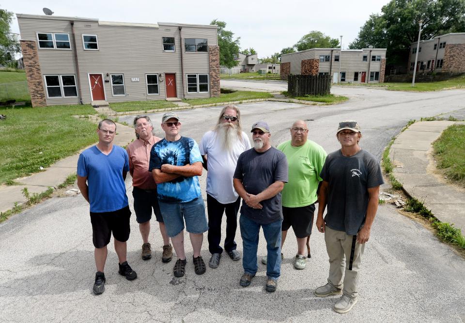 Some of the neighbors who live around Olde Towne Apartments stand by the Karl Lane entrance on June 18, 2024. Olde Towne's 23 buildings have been vacant since May 1, but neighbors have complained about people stealing metalwork and other items from the units.