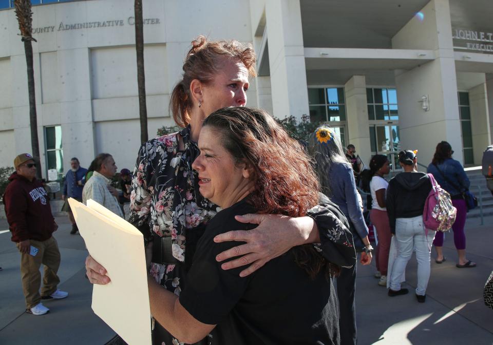 Karrie Schaaf, left, and Katherine Nigro hug after speaking at a rally Tuesday in Riverside. Nigro's son, Michael Vasquez, died in custody. Schaaf's son, who has been in custody since 2019, had a best friend die in custody.