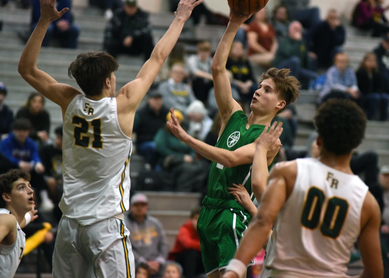 Ian Foster of SMCC shoots a floater over Flat Rock's Timmy Murphy during a 62-53 Flat Rock win Friday night.