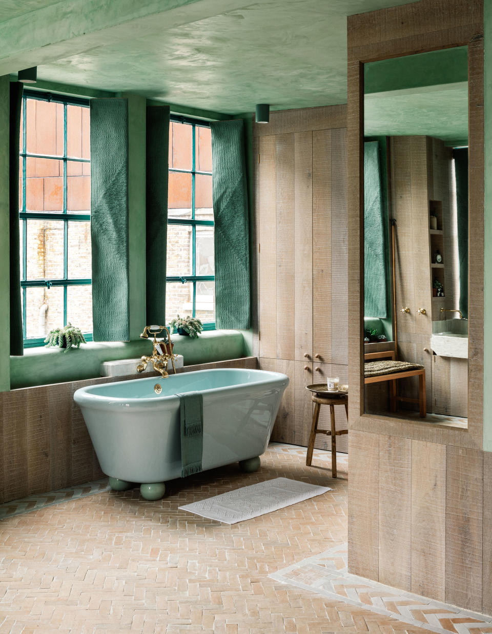 limed oak brushed timber planks with traditional lime plaster mixed with a natural green pigment on the walls and ceiling of a bathroom