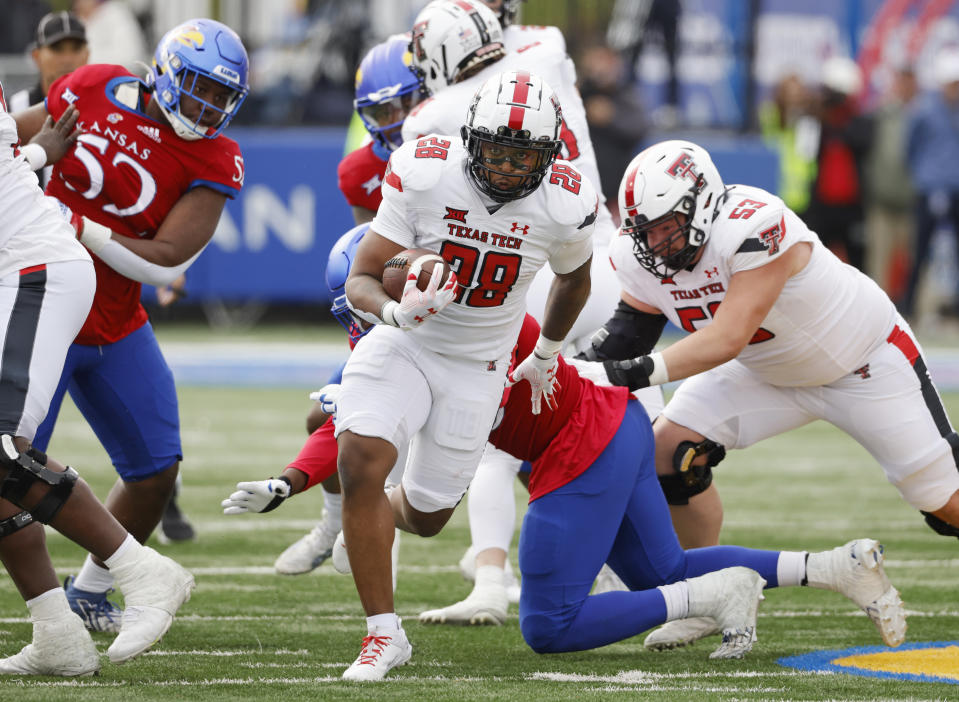 Texas Tech running back Tahj Brooks (28) rushes for a first down during the first half of an NCAA college football game against Kansas, Saturday, Nov. 11, 2023, in Lawrence, Kan. (AP Photo/Colin E Braley)