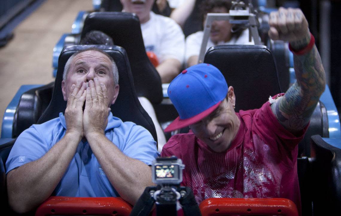 May 12, 2012: Six Flags Over Texas president Steve Martindale and rapper Vanilla Ice react after going on the first ride on Mr. Freeze: Reverse Blast, as it opened