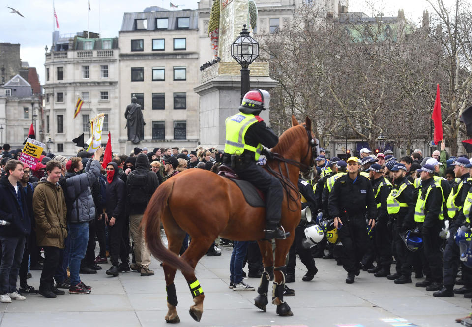 Police attempt to keep rival Brexit protest groups from clashing in central London, Sunday Dec. 9, 2018. The "Brexit Betrayal Rally" led by English far-right activist Tommy Robinson and UK Independence Party, UKIP, leader Gerard Batten, protesting for a split from Europe, and a Pro-Europe anti-fascist counter-demonstration both marched in central London. (Victoria Jones/PA via AP)