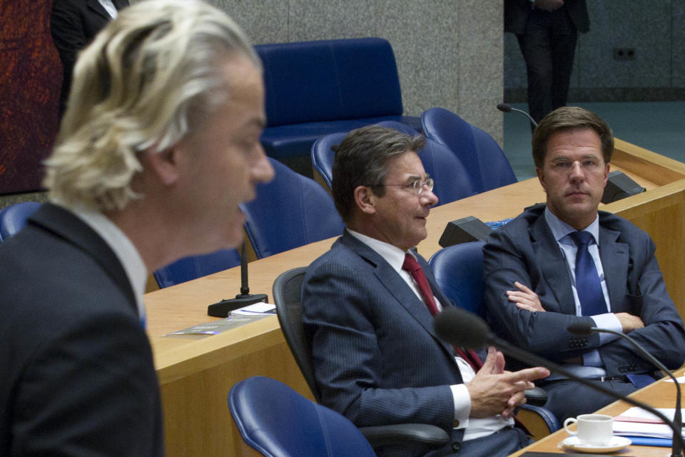 Caretaker Prime Minister Mark Rutte, right, and deputy prime minister Maxime Verhagen, center, listen to anti-EU lawmaker Geert Wilders, left, as he addresses parliament in The Hague, Netherlands, Tuesday April 24, 2012. Rutte appealed to a polarized Dutch Parliament on Tuesday to help him get the economy back on track rather than let the country drift in political limbo until new elections. Speaking publicly for the first time since he tendered his resignation Monday, Rutte said the nation, long considered one of Europe's most fiscally responsible, has no time to waste in tackling its economic woes. (AP Photo/Peter Dejong)