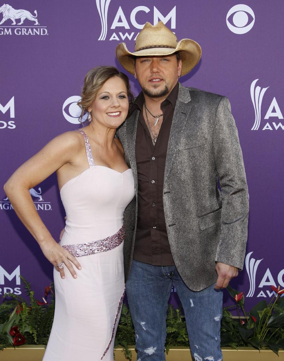 Jason Aldean, left, and Jessica Aldean arrive at the 47th Annual Academy of Country Music Awards on Sunday, April 1, 2012 in Las Vegas. (AP Photo/Isaac Brekken)