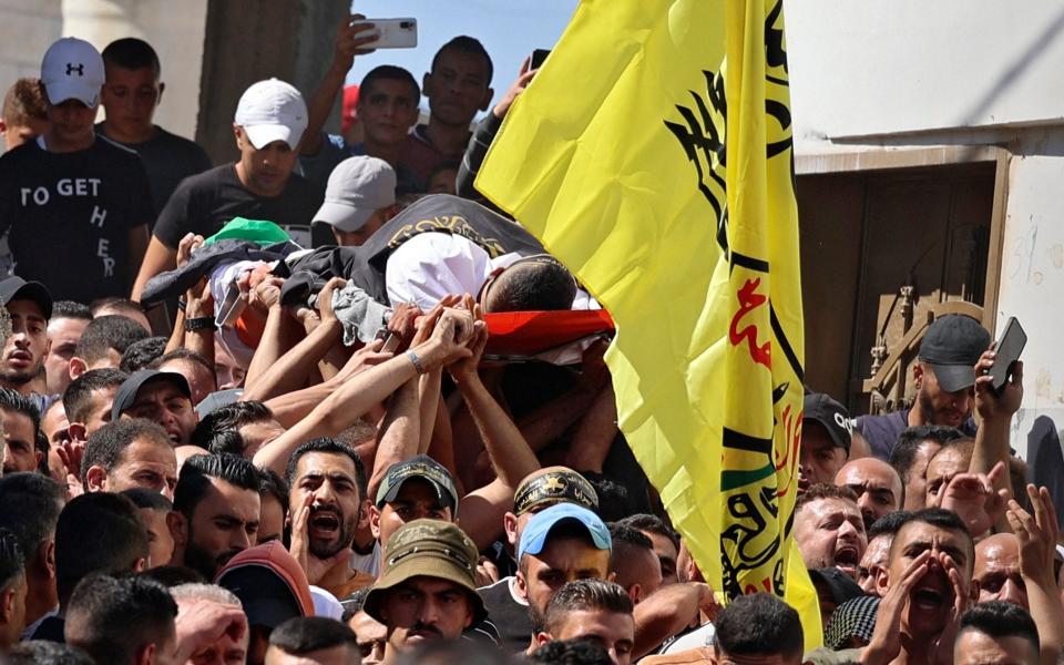 Mourners carry the body of Osama Sobh, a Palestinian killed by Israeli soldiers during clashes near Jenin - JAAFAR ASHTIYEH /AFP