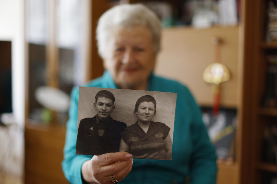 Holocaust survivor Assia Gorban, shows a picture of her and her brother Yitzhak during an interview with The Associated Press in Berlin, Germany, Monday, April 3, 2023. Over 100 Holocaust survivors and their descendants are participating in a new social media campaign that illustrates the importance of passing on the Holocaust survivors’ testimonies as their numbers dwindle. (AP Photo/Michele Tantussi)