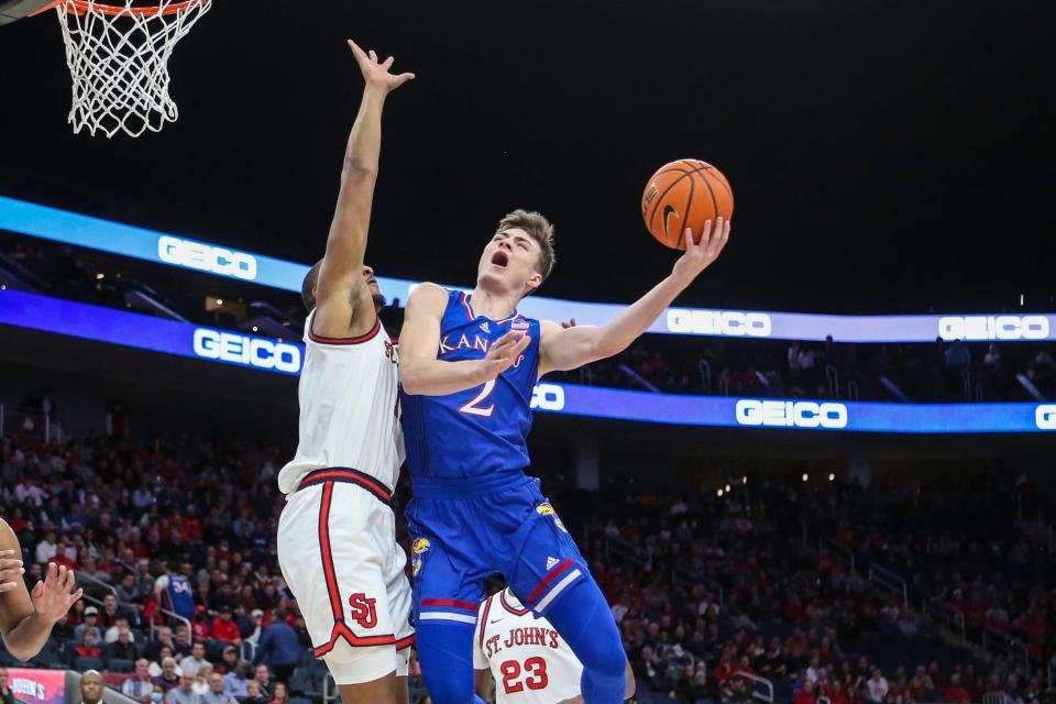 Dec 3, 2021; Elmont, New York, USA;  Kansas Jayhawks guard Christian Braun (2) puts up a shot while defended by St. John’s Red Storm center Joel Soriano (11) in the first half at UBS Arena. Mandatory Credit: Wendell Cruz-USA TODAY Sports