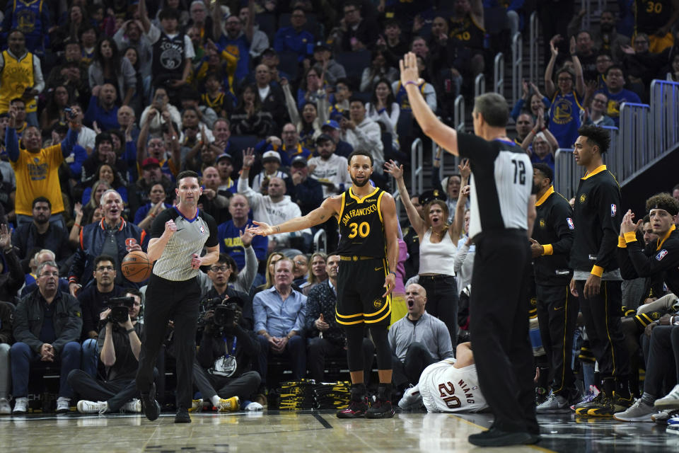 Golden State Warriors guard Stephen Curry (30) reacts to a foul call during the first half of an NBA basketball game against the Cleveland Cavaliers on Saturday, Nov. 11, 2023, in San Francisco. (AP Photo/Loren Elliott)