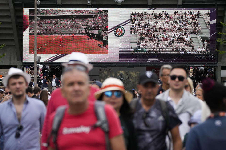 Spectators head to courts during first round matches at the French Open tennis tournament in Roland Garros stadium in Paris, France, Sunday, May 22, 2022. (AP Photo/Christophe Ena)