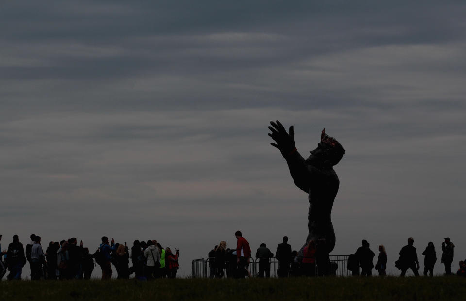 SALISBURY, ENGLAND - JUNE 21:  People gather around the Ancestor monument as revelers celebrate the arrival of the midsummer dawn at the megalithic monument of Stonehenge on June 21, 2012 near Salisbury, England. (Photo by Matt Cardy/Getty Images)