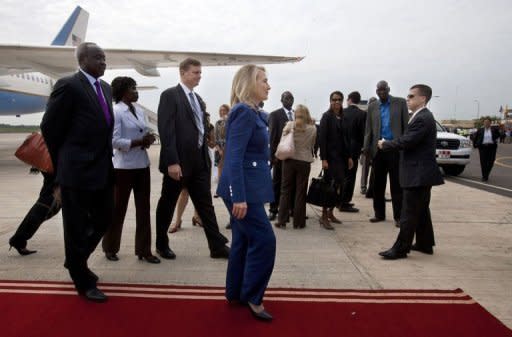 US Secretary of State Hillary Clinton(C) and South Sudan's Foreign Minister Nhial Deng Nhial, far left, walk to a vehicle as the Secretary arrives for her first visit to South Sudan at Juba International Airport. Clinton warned that "significant challenges" face the world's youngest nation, with "persistent poverty in a land rich with natural resources."