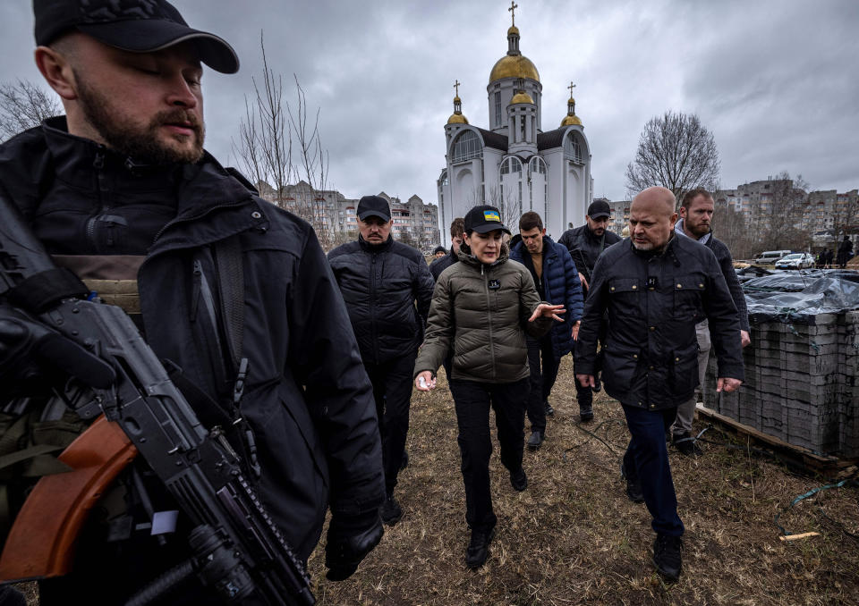 Ukraine's Prosecutor General Iryna Venediktova (C) and Prosecutor of the International Criminal Court, Karim Khan (R), visit a mass grave on the grounds of the Church of Saint Andrew in Bucha on April 13<span class="copyright">Fadel Senna—AFP/Getty Images</span>