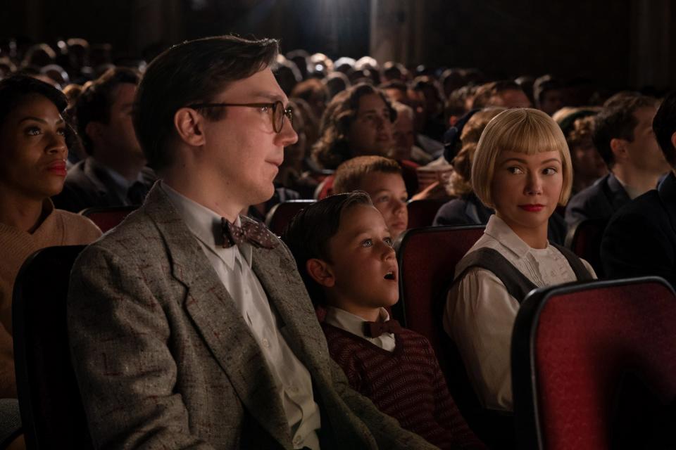 Sammy Fabelman (Mateo Zoryon Francis-DeFord, center) goes to the movies for the first time with his father Burt (Paul Dano) and mother Mitzi (Michelle Williams) in Steven Spielberg's "The Fabelmans."