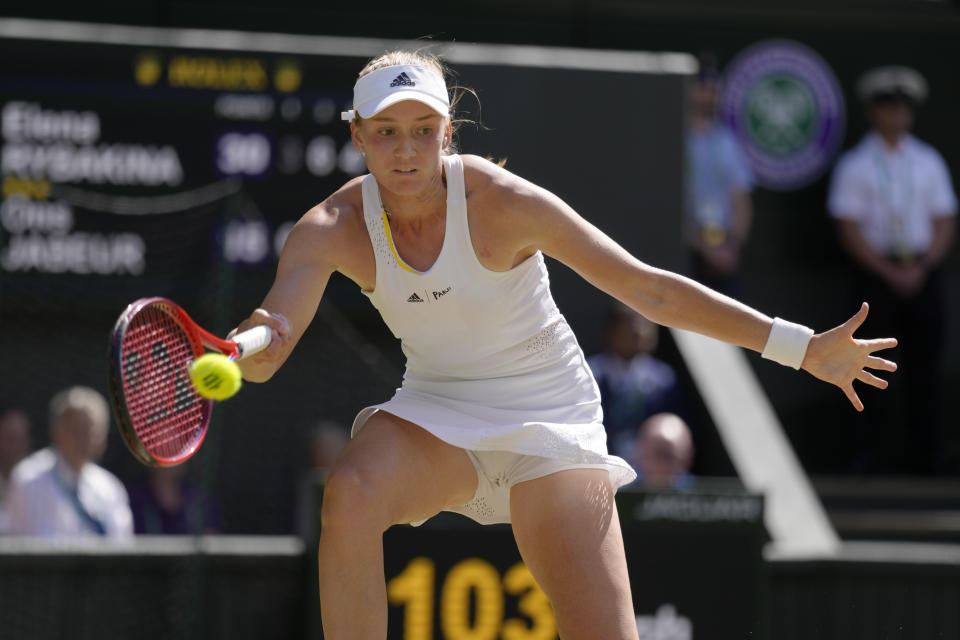 Kazakhstan's Elena Rybakina returns to Tunisia's Ons Jabeur in the final of the women's singles on day thirteen of the Wimbledon tennis championships in London, Saturday, July 9, 2022. (AP Photo/Kirsty Wigglesworth)