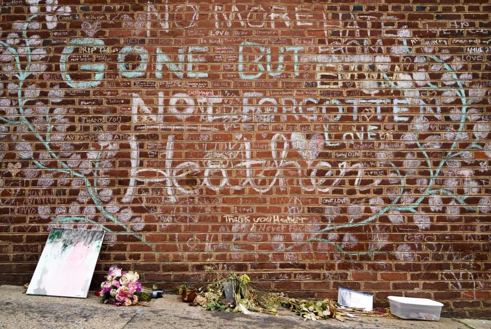 Flowers and gifts sit under the memorial wall for Heather Heyer in Charlottesville, Virginia, just off the honorary Heather Heyer Way. The city renamed a stretch of Fourth Street for Heyer, 32, who was killed by a self-avowed white supremacist who rammed his car into counterprotesters of a Unite the Right rally in 2017.