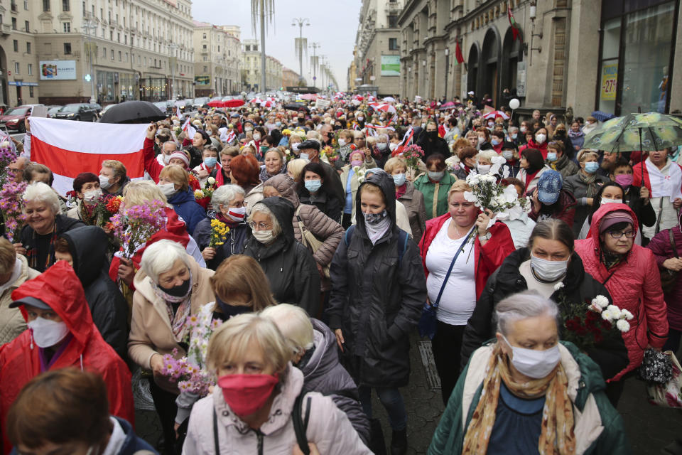 People, most of them elderly women, walk during an opposition rally to protest the official presidential election results in Minsk, Belarus, Monday, Oct. 12, 2020. Riot police clashed with protesting pensioners in central Minsk on Monday. The pensioners marched in a column through central Minsk, carrying flowers and posters with slogans such as "The grandmas are with you (protesters)." (AP Photo)