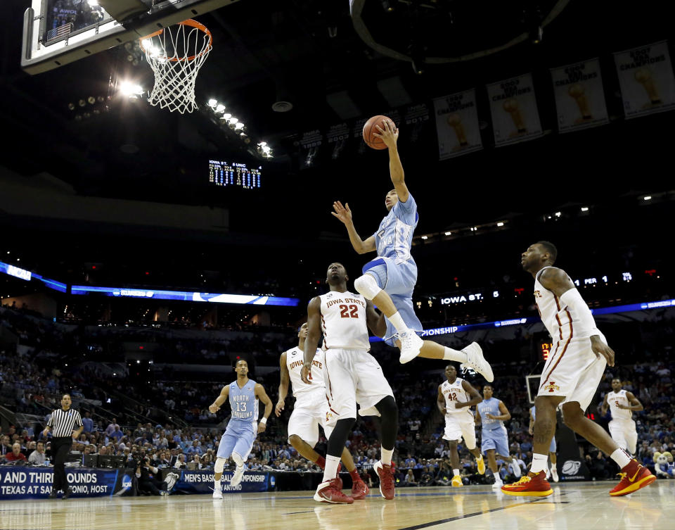 North Carolina's Marcus Paige (5) goes up for a shot as Iowa State's Dustin Hogue (22) defends during the first half of a third-round game in the NCAA college basketball tournament Sunday, March 23, 2014, in San Antonio. (AP Photo/David J. Phillip)