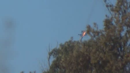 A war plane crashes in flames in a mountainous area in northern Syria after it was shot down by Turkish fighter jets near the Turkish-Syrian border November 24, 2015. REUTERS/Sadettin Molla