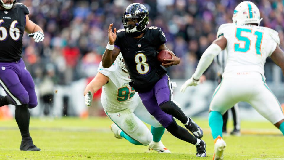 Jackson scrambles and runs with the ball during the Baltimore Ravens' game against the Miami Dolphins. Jackson threw for five touchdowns in the 56-19 win. - Michael Owens/Getty Images